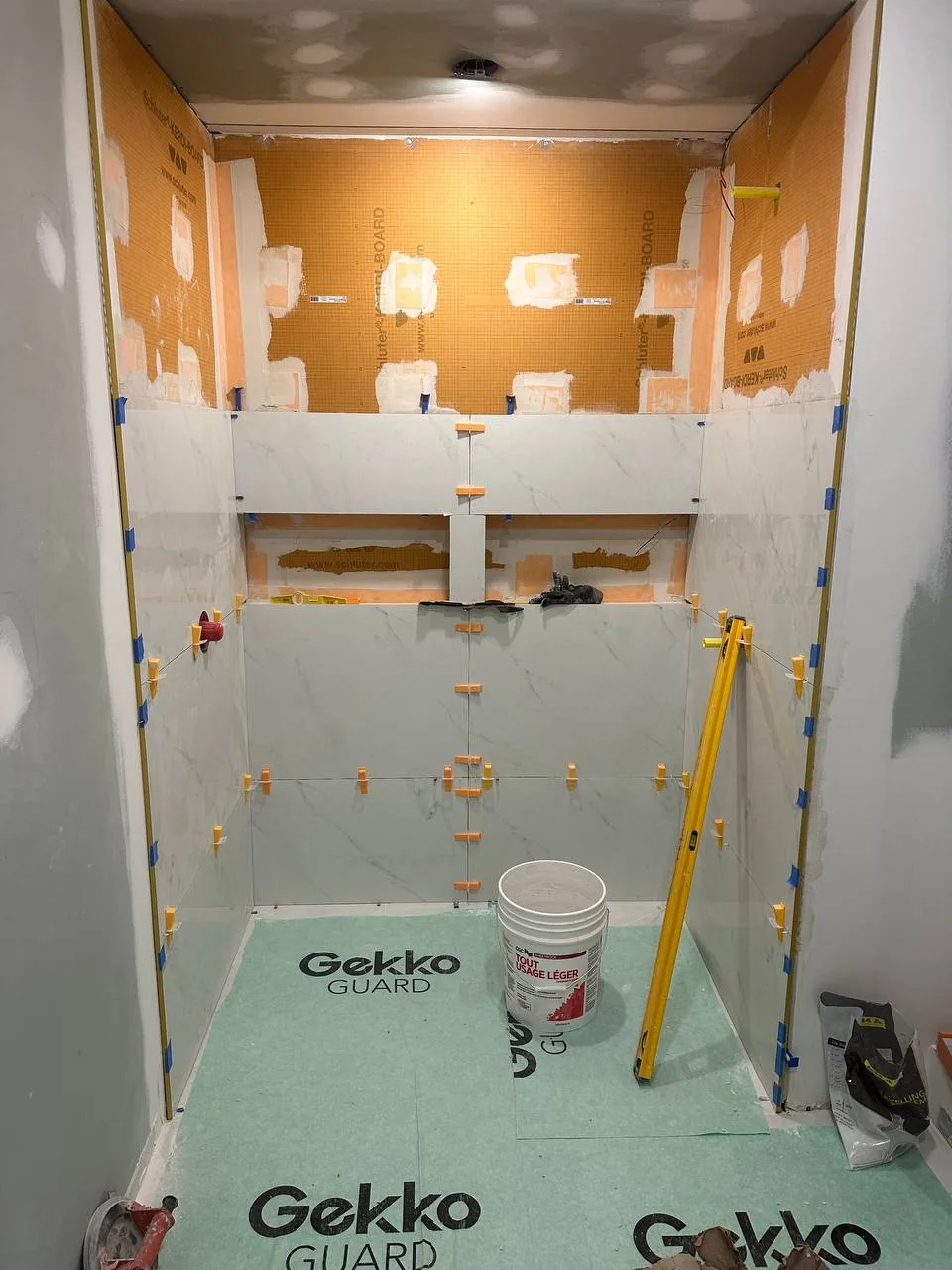 Shower niche and bench formed in waterproof board with every seam sealed before tiling