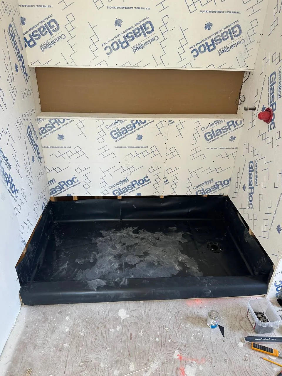 Completed shower pan liner turned up all four walls above the height of the finished curb